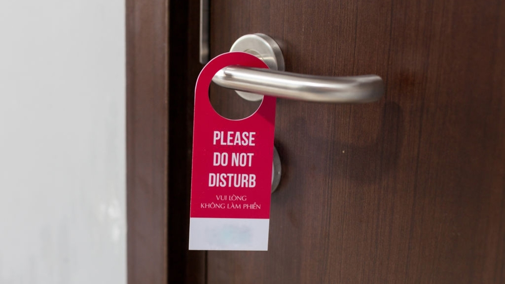 The hotel room with do not disturb sign on the door handle